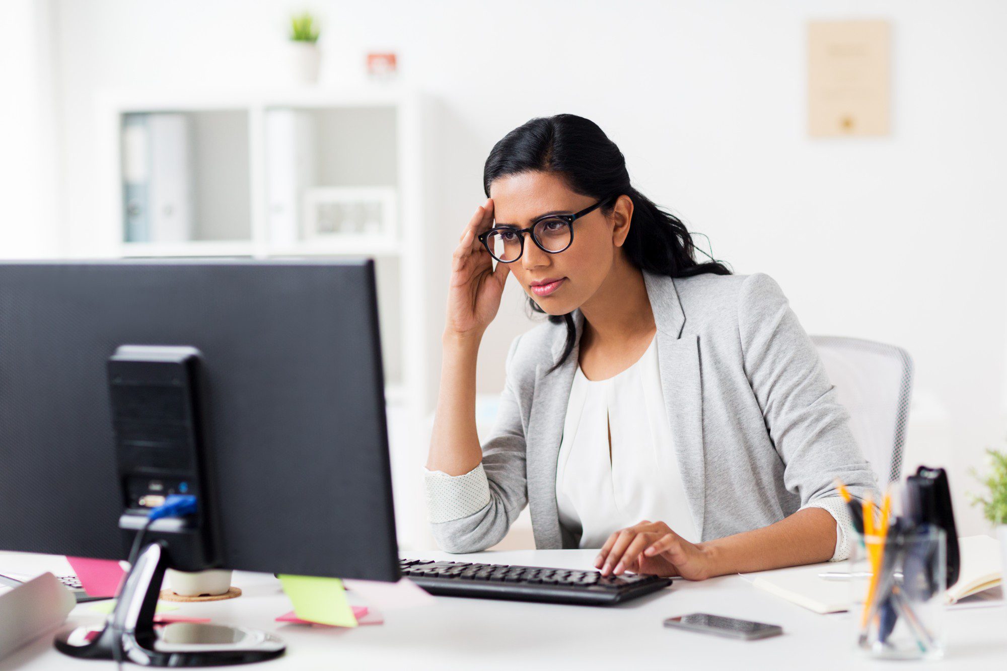 stressed businesswoman with computer at office