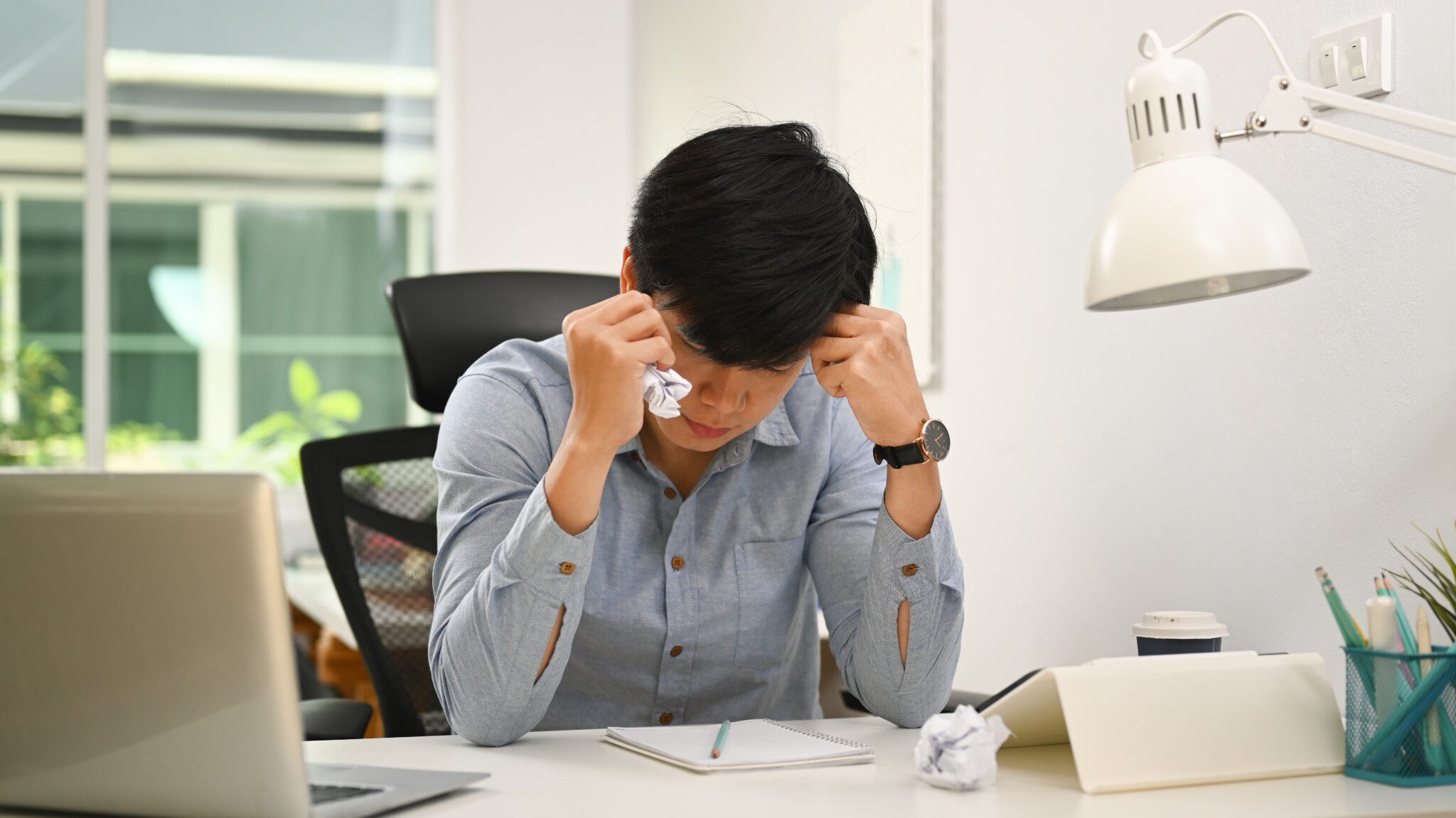Frustrated businessman looking information on paperwork and crum
