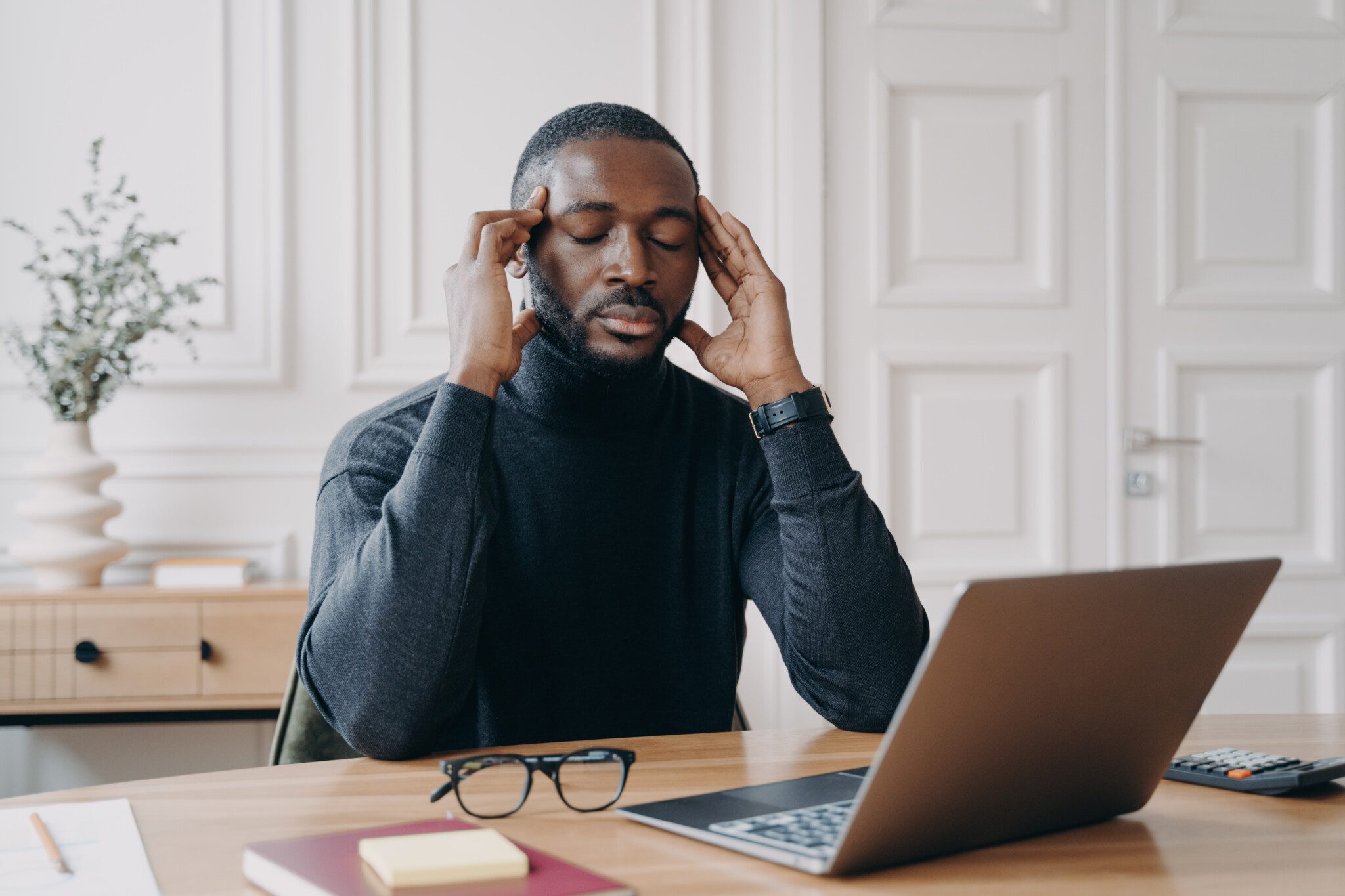 Frustrated tired man office worker with closed eyes trying to concentrate at workplace