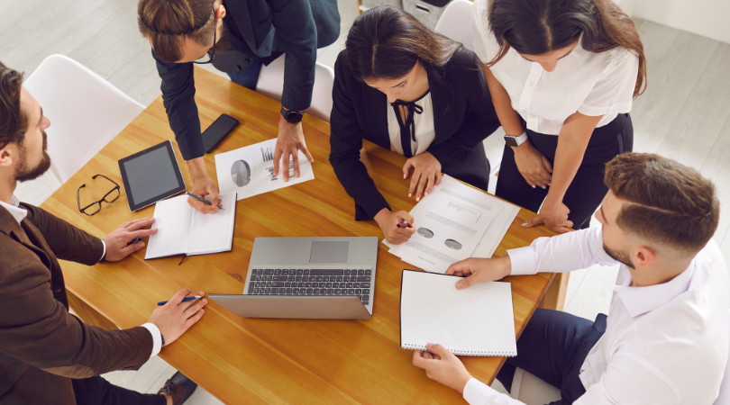 Management team using sage software reports to analyze financials