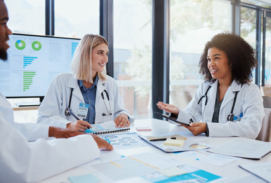 Healthcare, meeting and teamwork with a doctor and her team planning for growth, research and innovation in the medical industry. Collaboration, medicine and communication with a woman surgeon.