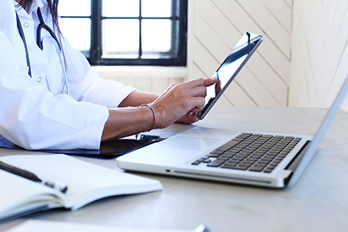 Doctor working on tablet